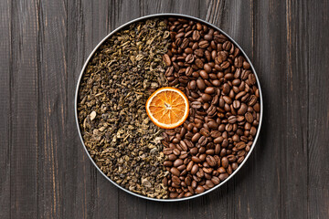 Green tea and coffee grains on a dark wooden background top view.