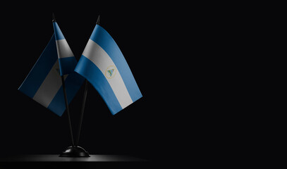 Small national flags of the Nicaragua on a black background
