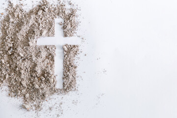 Christian cross or crucifix drawing in ash, dust or sand as symbol of religion, sacrifice,...