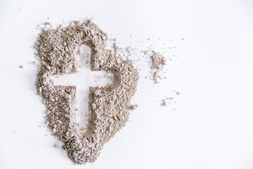 Christian cross or crucifix drawing in ash, dust or sand as symbol of religion, sacrifice,...