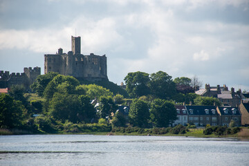 Fototapeta na wymiar Warkworth Castle from across the River Coquet, close to Amble in Northumberland, UK