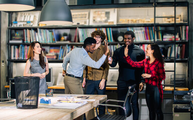 Group diverse multiracial businesspeople wearing casual clothes in modern office, taking break, rest, playing games with relaxation, throwing paper ball to the target. Achievement, Success Concept.