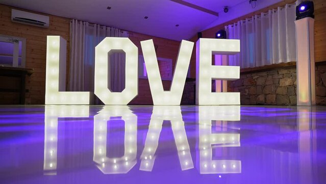 Decorative word from luminous lamp letters love at the wedding and Valentine's day. Glowing inscription