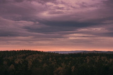 pink sky in the morning with forest in Austria