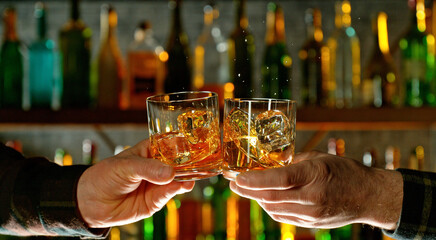 Close-up view of a two whiskey shots in hands.