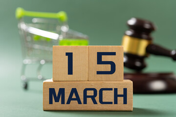 MARCH 15 in front and shopping cart and judge gavel on back concept of world consumer rights day