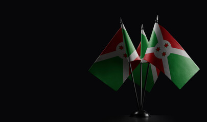 Small national flags of the Burundi on a black background