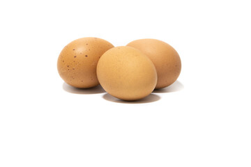 Three brown chicken eggs. Isolated on a white background. Vegetarian food concept.
