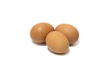 Three brown chicken eggs. Isolated on a white background. Vegetarian food concept.