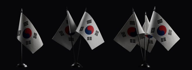 Small national flags of the South Korean on a black background