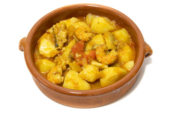Potato stew with cod, served in a clay bowl. Isolated on white background. Spanish food concept.