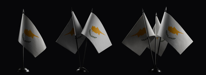 Small national flags of the Cyprus on a black background