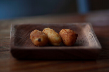 potato fingers snack on a wooden plate decorated with a cinnamon stick