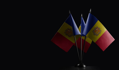 Small national flags of the Andorra on a black background