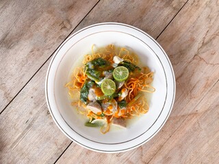 Indonesia food namely Mie Kering or dry fried noodles with toppings chicken, meatballs, vegetables, beaten egg and thick broth. Commonly popular in Asia food.