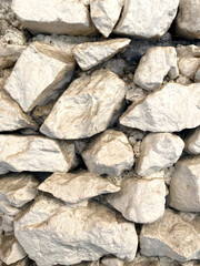 Coarse natural rock, Stone background. Mining cliff rough front surface.