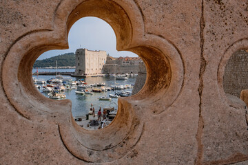 Old port of Dubrovnik through a detail of the bridge, creative, Croatia
