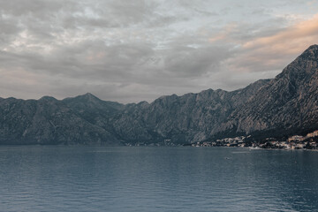 Fototapeta na wymiar Perfect landscape, view of Kotor bay during sunset, mountains and sea, soft colours, background creative edit