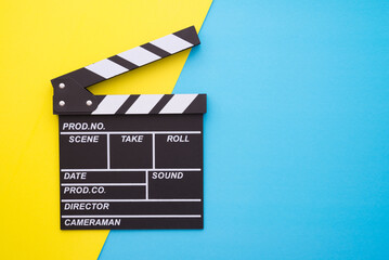 Cinema clapperboard on yellow blue colorful background - Movie cinema entertainment concept