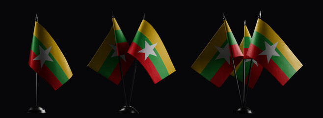 Small national flags of the Myanmar on a black background