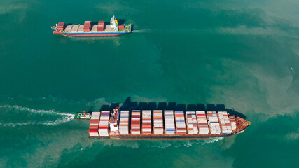 two cargo container ship sailing in sea to import export goods and distributing products to dealer...