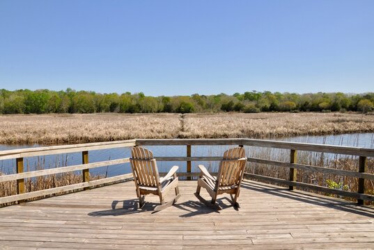 Rocking chairs on deck overlooking low country creek and marsh