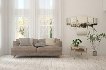 Fototapeta premium White living room with sofa and summer landscape in window. Scandinavian interior design. 3D illustration