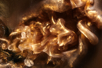 Black gold abstract ocean background. Splashes and waves of sparkling paint under water, clouds of interstellar smoke in motion