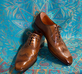 brown male business leather shoes on blue background