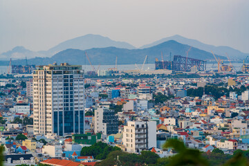 Night in panoramic coastal Vung Tau view from above, with waves, coastline, streets, coconut trees and Tao Phung mountain in Vietnam.