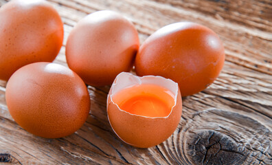 Composition with five chicken eggs on a wooden table