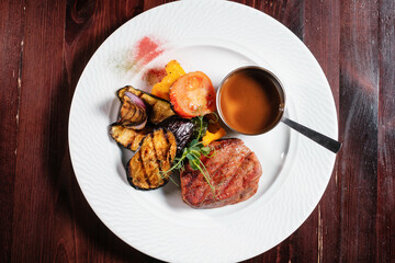 Steak grilled with vegetables top view.