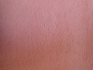 Pink wall texture. Background picture. Stone texture. The wall is painted pink.