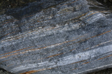 Background picture. Stone texture. Cut stone. Geological layers in the rock.