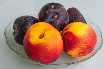 PLUMS, PEACHES AND AVOCADOS IN A BOWL