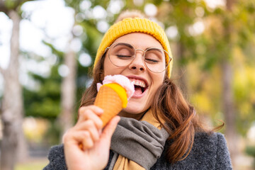 Brunette woman with a cornet ice cream at outdoors