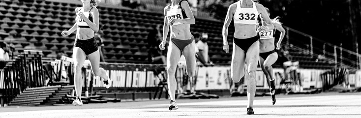 race woman runners sprinters run track black and white image
