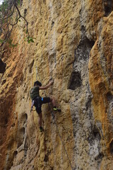Rock climbing at Goa Pawon cliff in Bandung, West Java, Indonesia