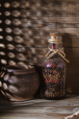 Allspice in a glass bottle on a rustic table