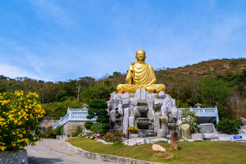 The beautiful morning at the Golden Buddha holding a lotus flower at Chon Khong Monastery attracts tourists to visit on weekends in Vung Tau. Travel concept