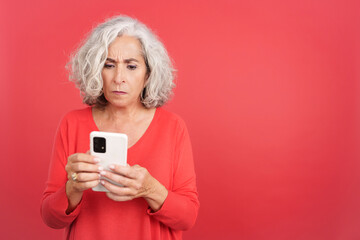 Worried mature woman using a mobile phone