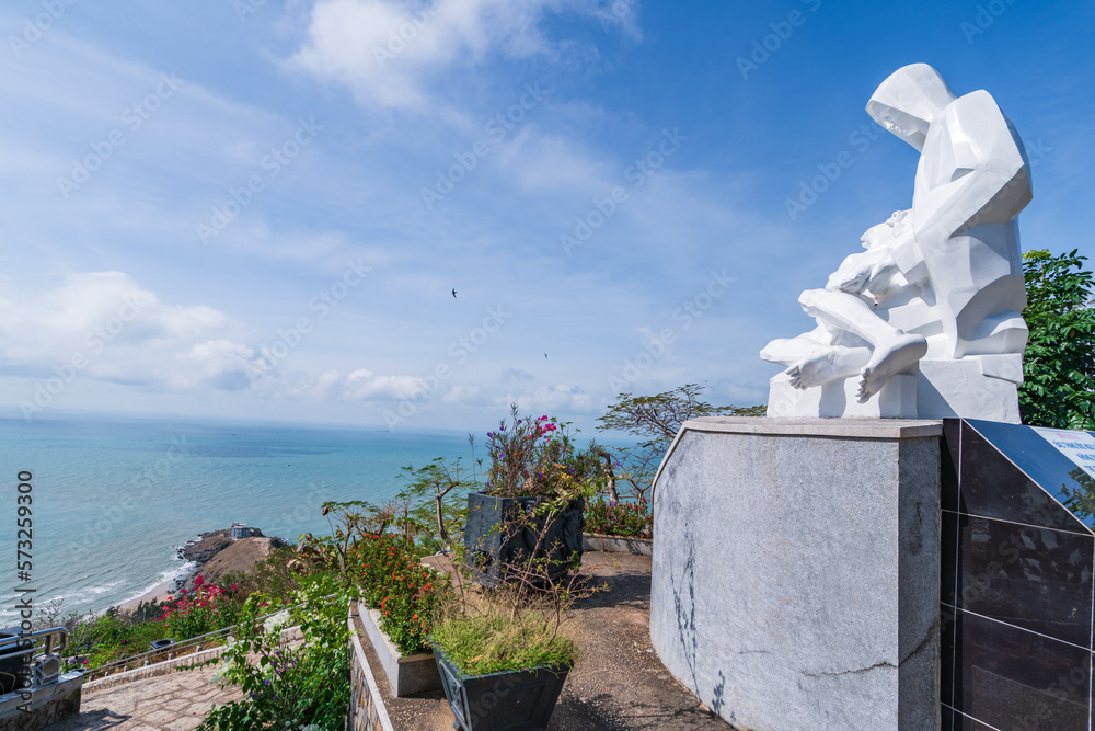 Wall mural Statue of Jesus Christ at Tao Phung mountain, one of the famous tourist attractions in the coastal city of Vung Tau. Where you can see the whole beautiful coastal city. Travel concept