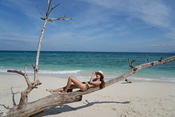 Fototapeta na wymiar woman with a hat and bikini on the beach in krabi thailand, poda island, model shooting