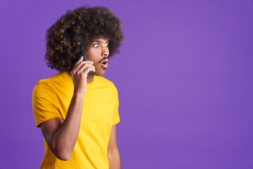 Fototapeta na wymiar Surprised african man talking to the mobile