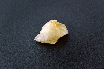 Crystal of Citrine yellow quartz mineral gem stone. Black background