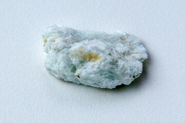 Macro stone albite mineral white background close up. Aquamarine on Albite