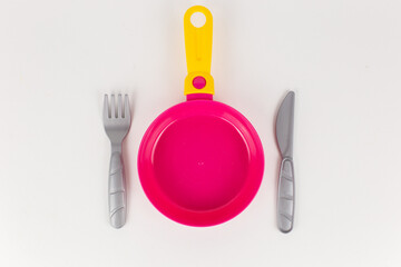 children's toy plastic frying pan on a white background