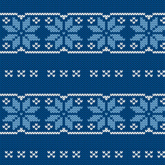 Seamless blue background with knitted snowflakes and stars for winter clothes