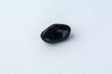 Natural mineral rock specimen polished black Onyx gemstone on white background