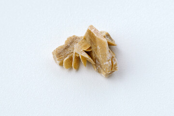 Fototapeta na wymiar Desert Rose. Natural mineral close up of stone cluster from sand gypsum crystal, white background